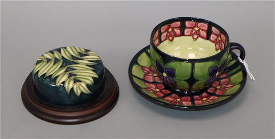 A Moorcroft Violets cup and saucer, seconds and a paperweight